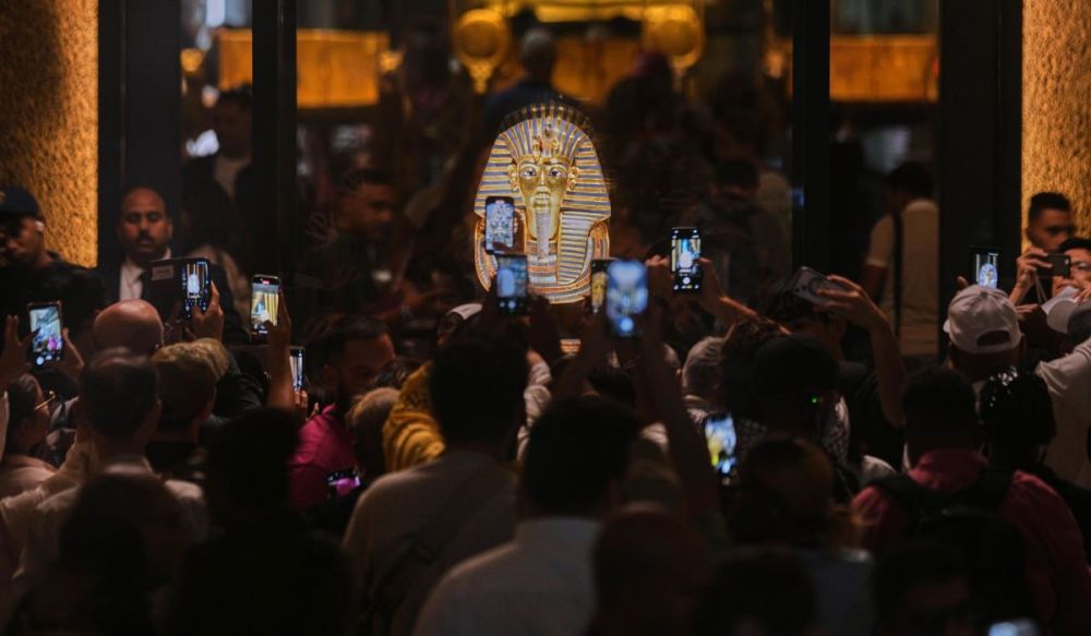 Посетители перед золотой погребальной маской фараона Тутанхамона.